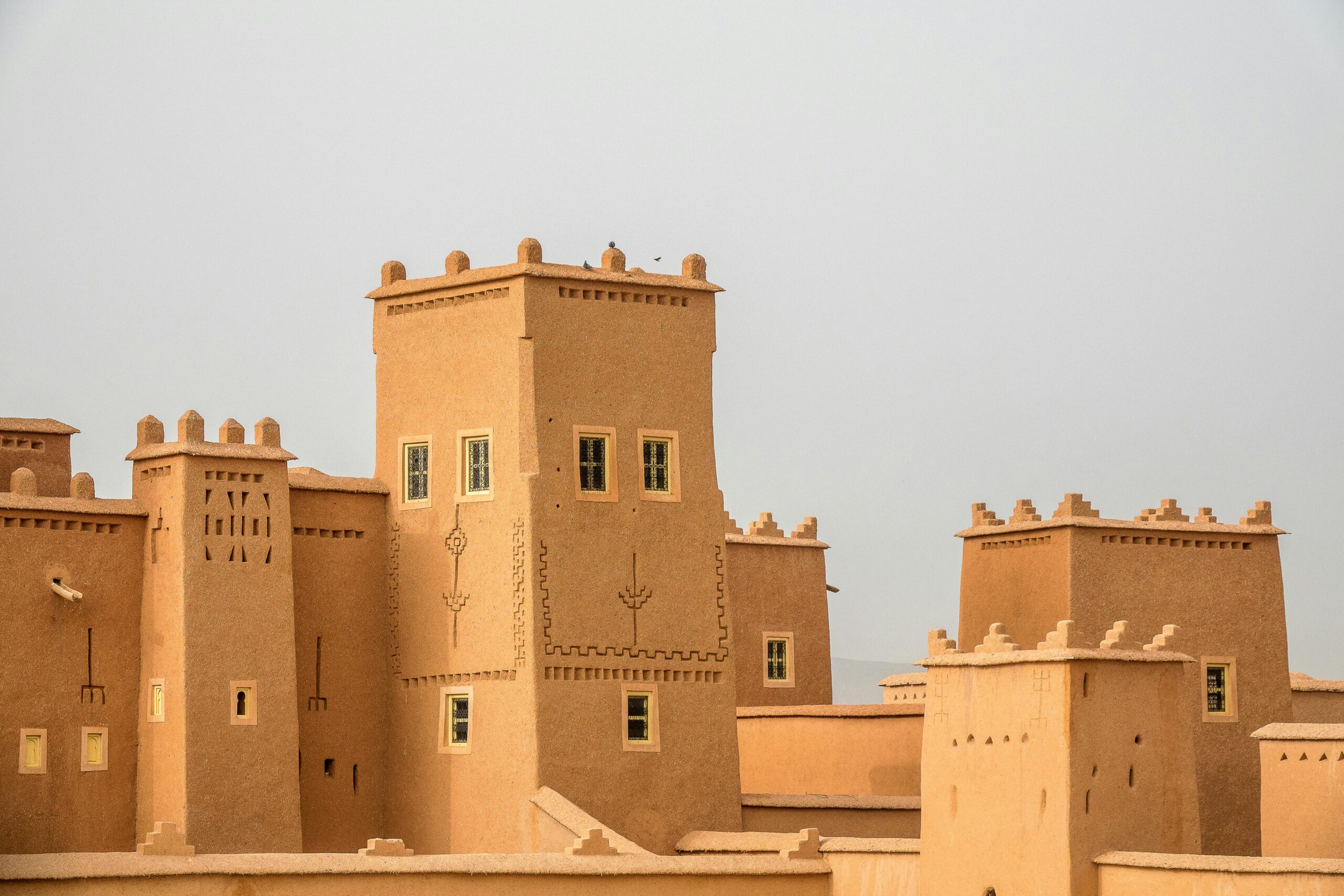 Traditional earthen architecture with towers, showcasing historical fortifications.